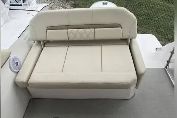 Slide: The Image of 2020 Regal 26 XO boat with beige cushioned seating on deck. - 22