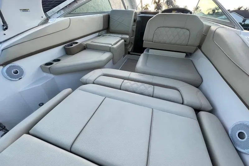 Slide: The Image of Luxurious interior of 2020 Regal 26 XO boat with beige seating and cup holders. - 26