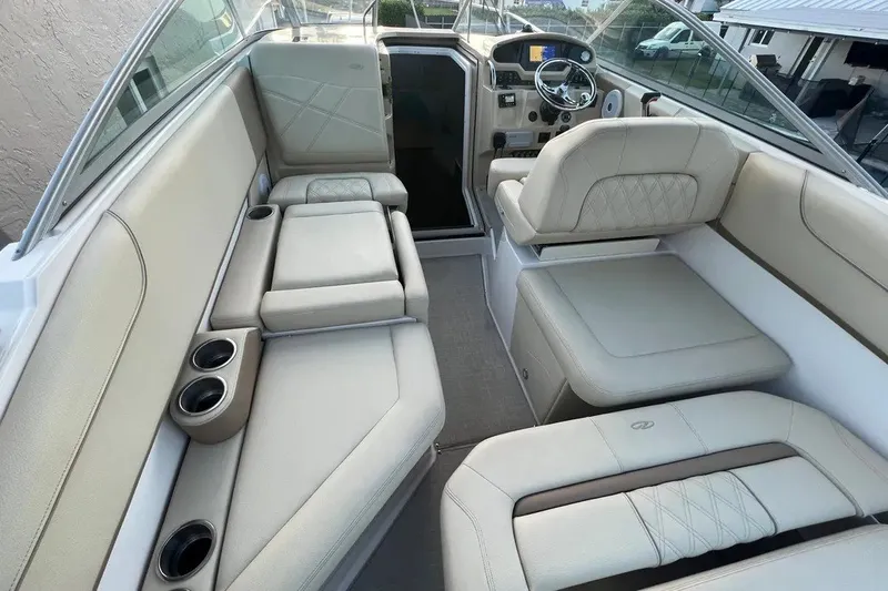 Slide: The Image of Interior of a 2020 Regal 26 XO boat with beige seating and cup holders. - 27