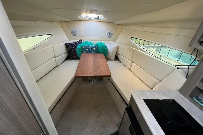 Slide: The Image of 2020 Regal 26 XO boat interior with cozy seating and wooden table. - 29