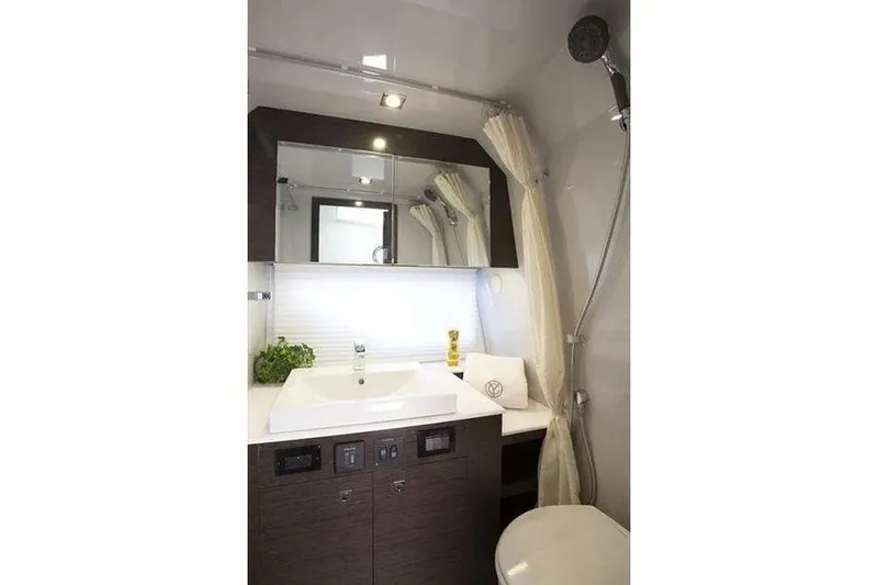 Slide: The Image of Modern bathroom interior of 2023 Cruisers Yachts 38 GLS OB, featuring sleek sink and shower. - 29