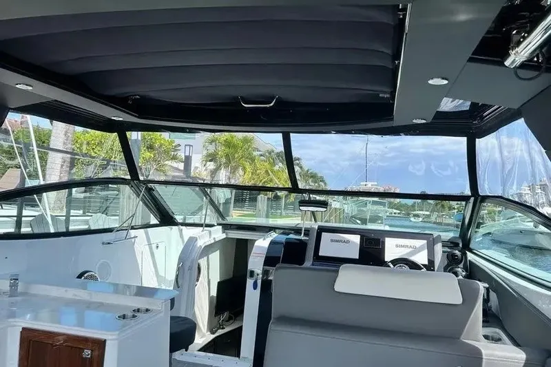 Slide: The Image of Interior view of 2023 Cruisers Yachts 38 GLS OB, featuring modern helm and seating. - 19