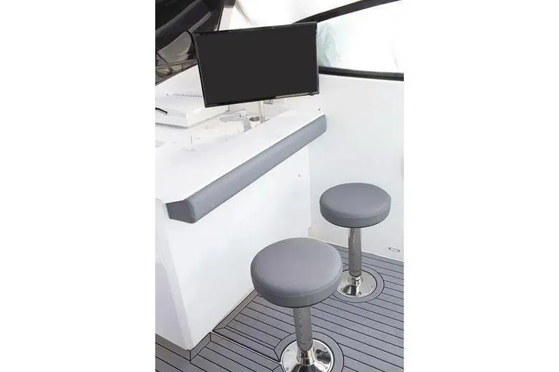 Slide: The Image of 2023 Cruisers Yachts 38 GLS OB interior with two stools and a counter. - 12