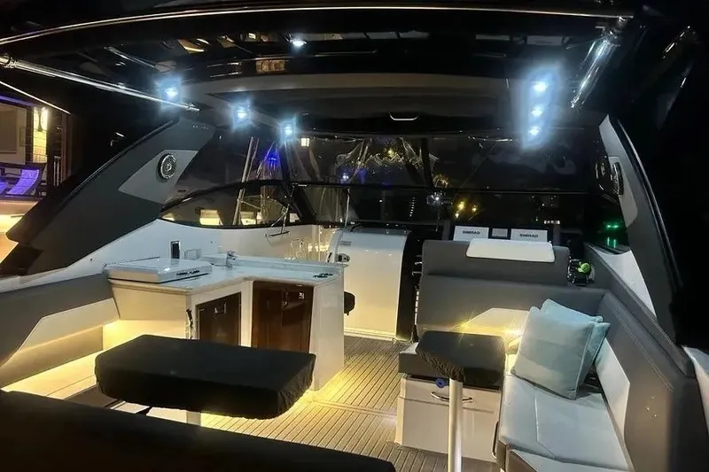 Slide: The Image of Luxurious interior of 2023 Cruisers Yachts 38 GLS OB, featuring modern seating and ambient lighting. - 25