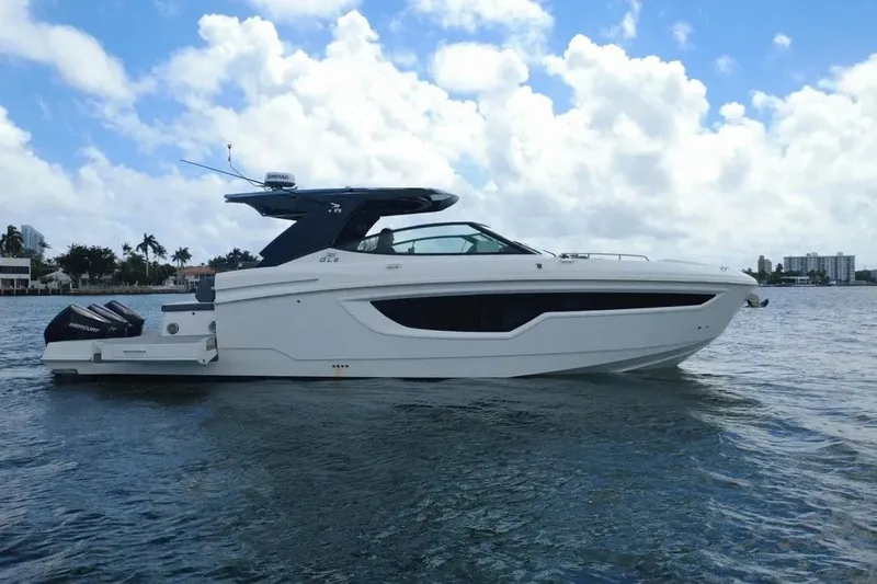 Slide: The Image of 2023 Cruisers Yachts 38 GLS OB on water, showcasing sleek design and powerful outboard engines. - 5
