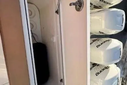 Slide: The Image of 2019 Scout 420 LXF boat storage compartment with powerful outboard engines. - 19