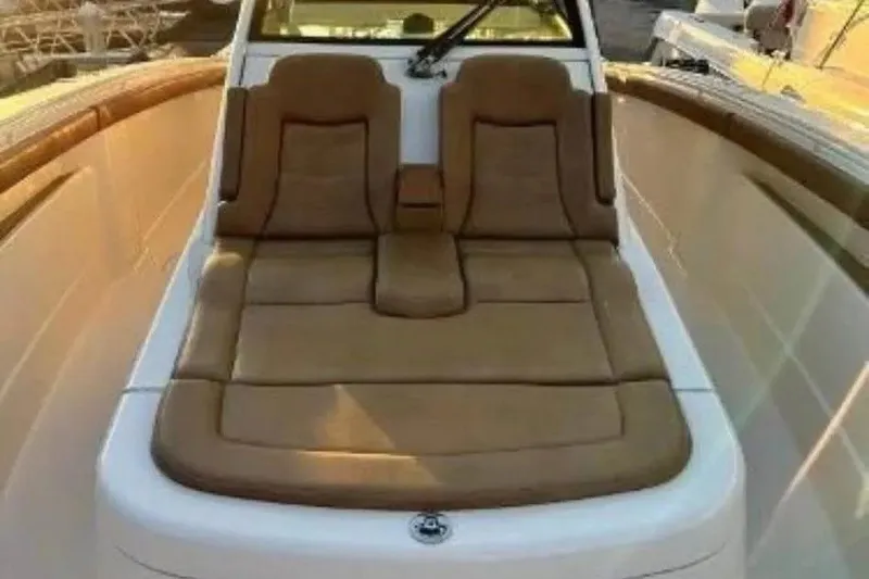 Slide: The Image of 2019 Scout 420 LXF boat with luxurious tan seating and sleek design. - 16
