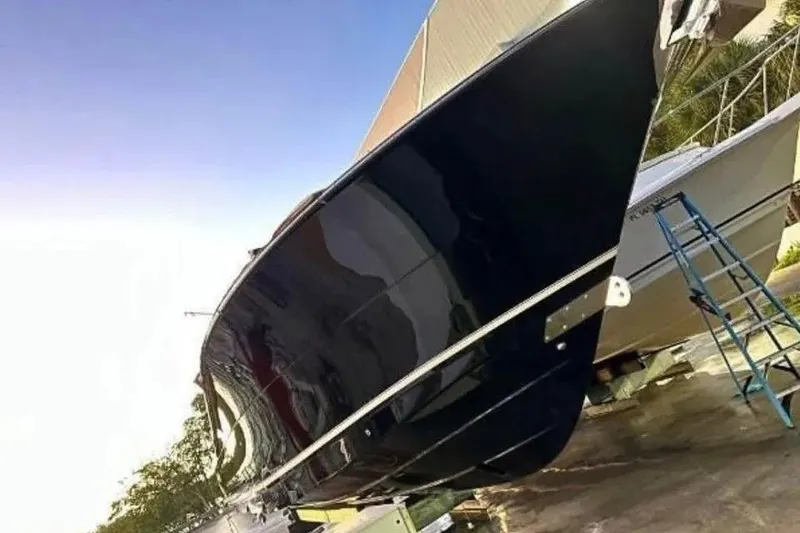 Slide: The Image of 2019 Scout 420 LXF boat on dry dock, side view with ladder. - 12