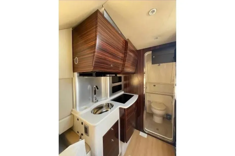 Slide: The Image of 2019 Scout 420 LXF interior with kitchenette and compact bathroom. - 39