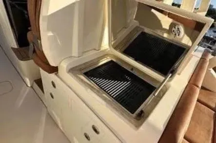 Slide: The Image of Outdoor grill on 2019 Scout 420 LXF boat, open lid, sleek design. - 22