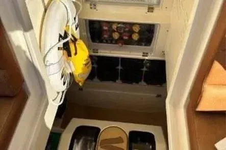 Slide: The Image of Interior view of 2019 Scout 420 LXF boat with life jackets and storage compartments. - 24