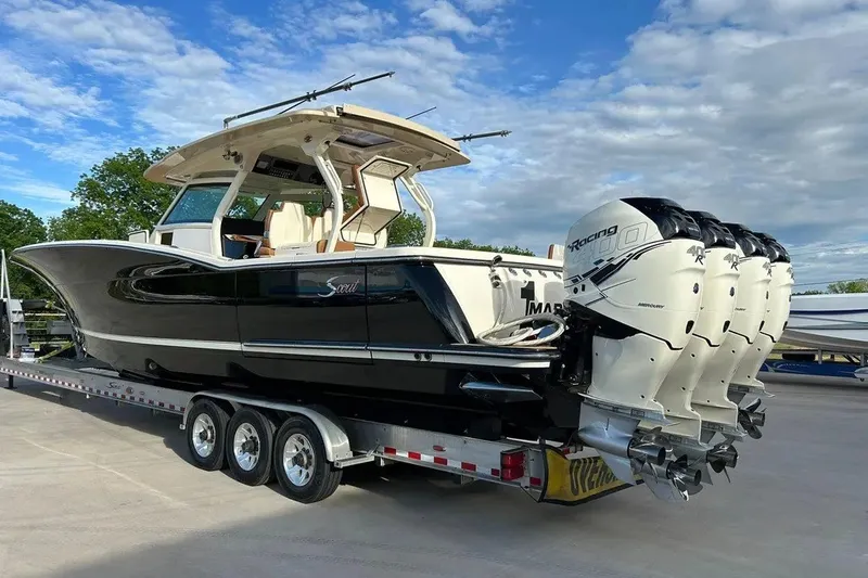 Slide: The Image of 2019 Scout 420 LXF boat on trailer with four powerful outboard engines. - 5