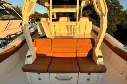 Slide: The Image of 2019 Scout 420 LXF boat interior with orange and brown seating. - 20