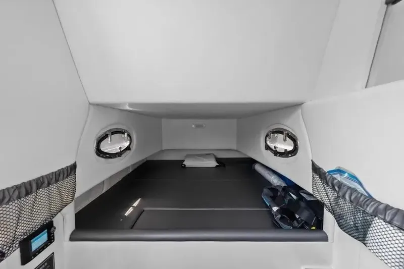 Slide: The Image of 2023 Nor-Tech 390 Center Console cabin interior with portholes and storage compartments. - 15