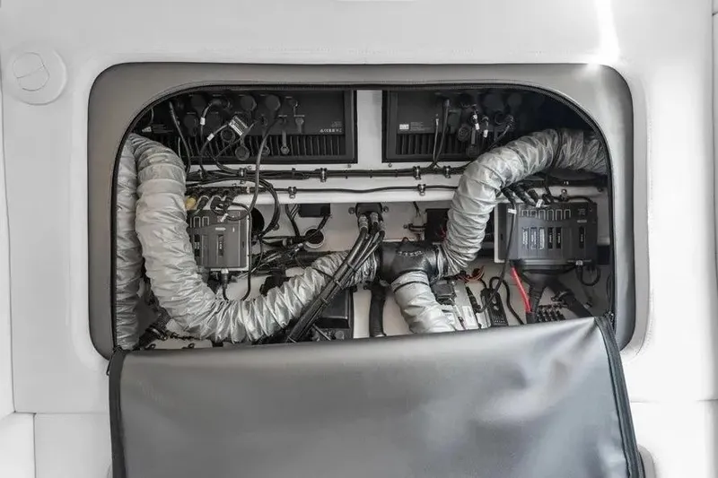 Slide: The Image of Electrical system inside 2023 Nor-Tech 390 Center Console boat, showcasing wiring and components. - 18