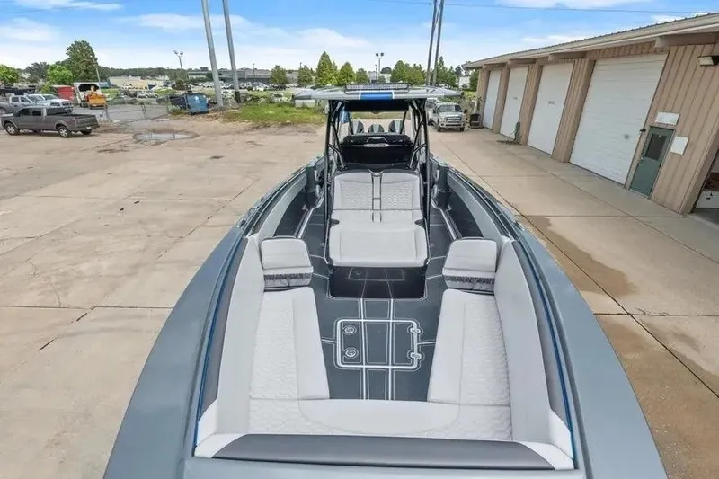 Slide: The Image of 2023 Nor-Tech 390 Center Console boat with spacious seating, docked outdoors. - 4