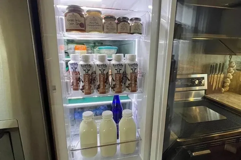 Slide: The Image of Refrigerator stocked with protein drinks and jars on a 2004 Lazzara SC Motor Yacht. - 27