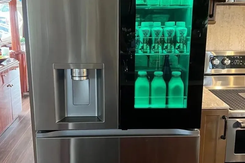 Slide: The Image of Modern stainless steel refrigerator with illuminated glass door, inside a 2004 Lazzara SC Motor Yacht. - 23