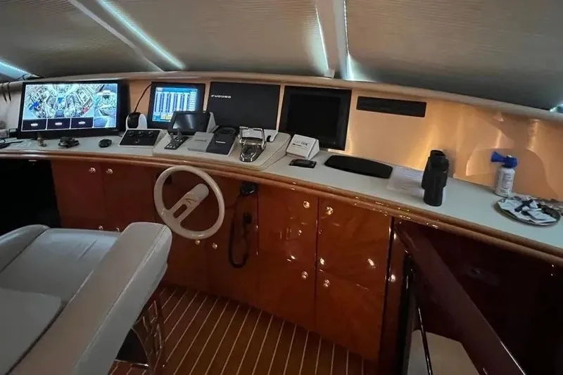 Slide: The Image of Control panel of a 2004 Lazzara SC Motor Yacht with navigation screens and equipment. - 49