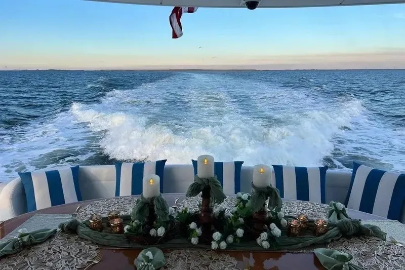 Slide: The Image of Luxurious 2004 Lazzara SC Motor Yacht with elegant table setting, cruising on open sea. - 77