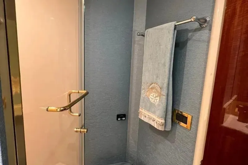 Slide: The Image of Luxurious bathroom interior of 2004 Lazzara SC Motor Yacht with elegant towel and gold accents. - 68