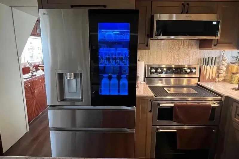 Slide: The Image of Modern kitchen on 2004 Lazzara SC Motor Yacht with stainless steel appliances and illuminated fridge. - 21
