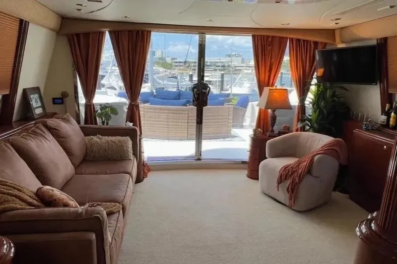 Slide: The Image of Luxurious interior of a 2004 Lazzara SC Motor Yacht with elegant furnishings and marina view. - 51