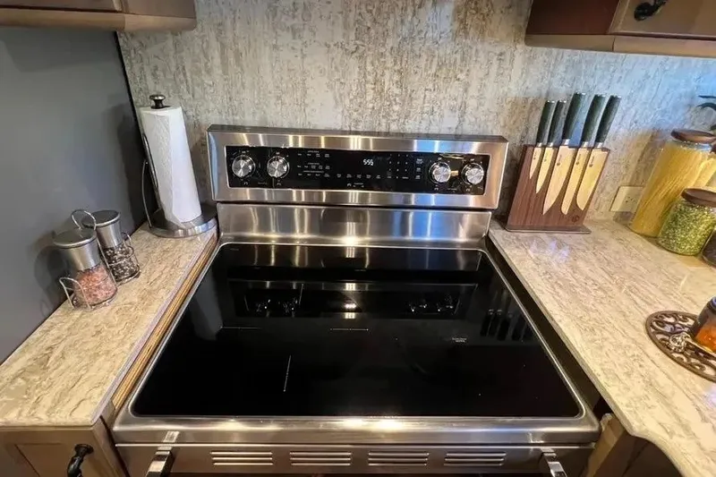 Slide: The Image of Modern kitchen stove with stainless steel finish, surrounded by countertop accessories. - 20
