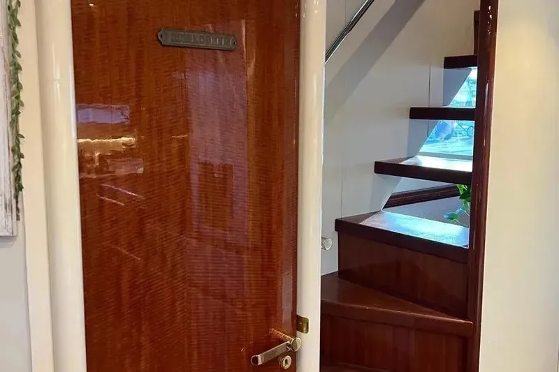 Slide: The Image of Interior of 2004 Lazzara SC Motor Yacht with wooden door and staircase. - 44