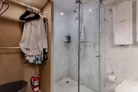 Slide: The Image of Luxurious bathroom on 2007 Lazzara LSX 75 yacht with marble shower and hanging clothes. - 46