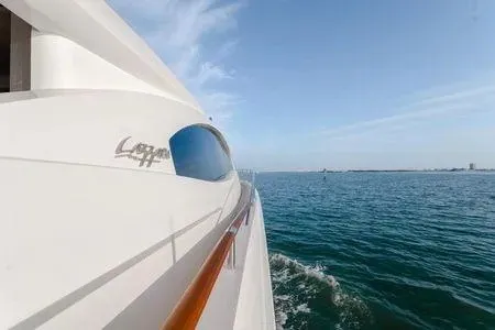 Slide: The Image of 2007 Lazzara LSX 75 yacht cruising on open water under clear blue skies. - 29