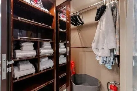 Slide: The Image of Luxurious 2007 Lazzara LSX 75 yacht closet with shelves, towels, hangers, and fire extinguisher. - 47