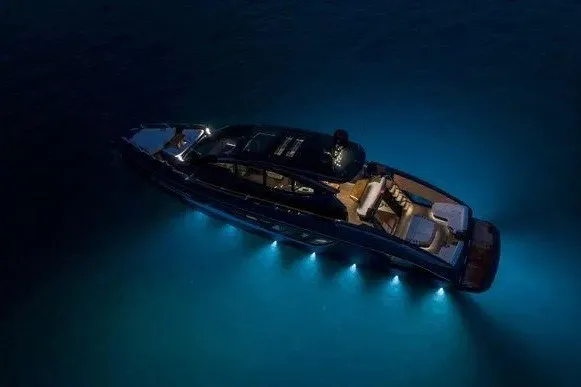 Slide: The Image of 2023 Lazzara LSX 67 yacht illuminated at night on calm water. - 27
