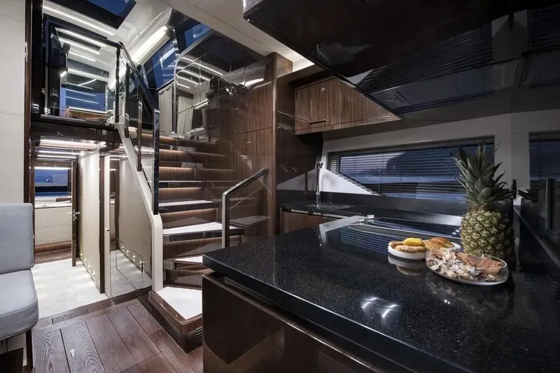 Slide: The Image of Luxurious interior of 2023 Lazzara LSX 67 yacht with modern kitchen and elegant staircase. - 19