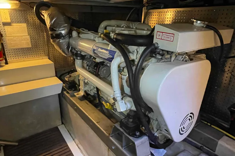 Slide: The Image of Engine room of a 2002 President Trawler with detailed machinery and components. - 84