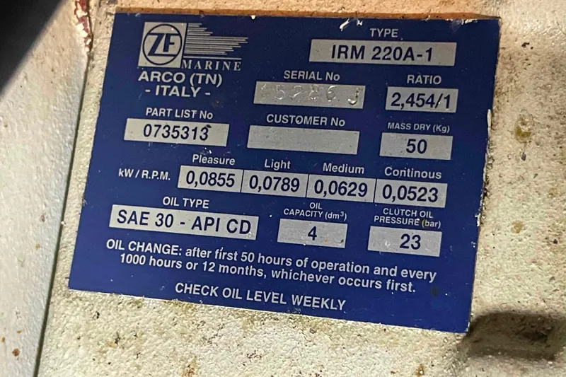 Slide: The Image of ZF Marine IRM 220A-1 label on 2002 President Trawler, detailing oil type and specifications. - 100