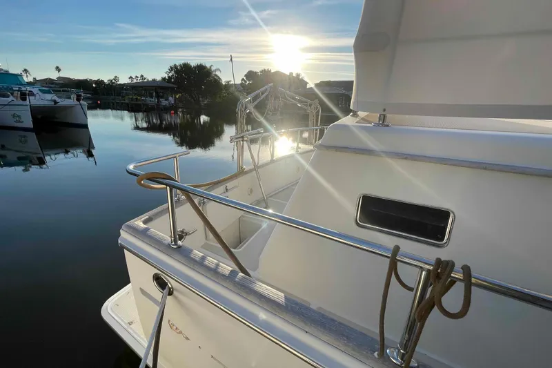 Slide: The Image of 2002 President Trawler docked at sunset, reflecting on calm water. - 30