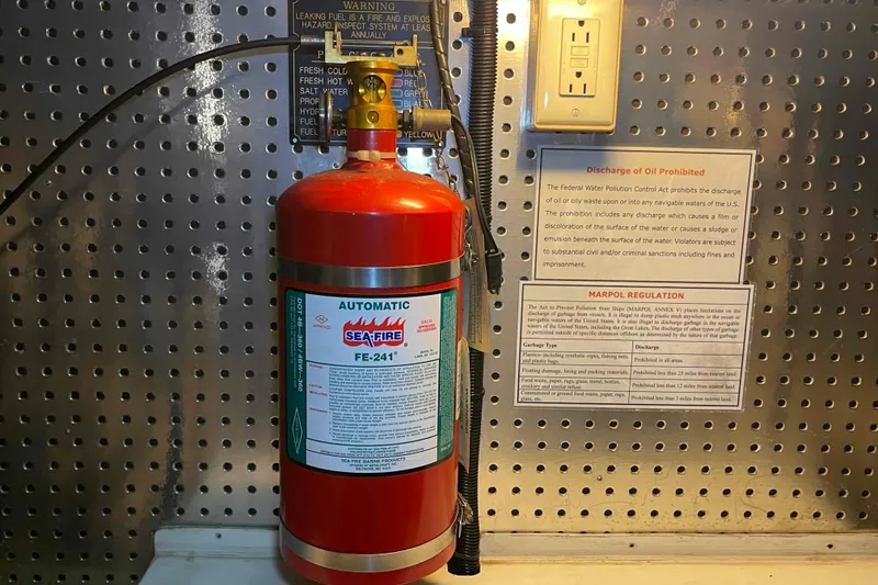 Slide: The Image of Automatic fire extinguisher on 2002 President Trawler, with safety and regulation notices. - 92