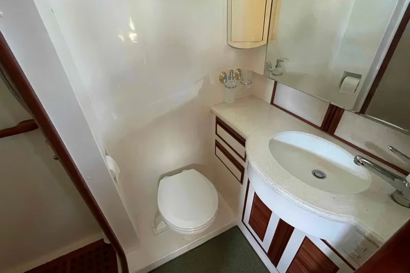 Slide: The Image of Compact bathroom in 2002 President Trawler with sink, toilet, and wooden accents. - 69