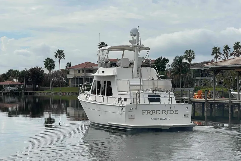 Slide: The Image of 2002 President Trawler boat named "Free Ride" in a serene waterfront setting. - 115