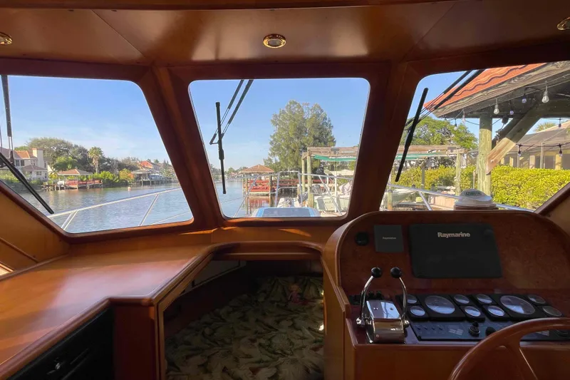 Slide: The Image of 2002 President Trawler helm view with scenic waterfront and navigational equipment. - 38