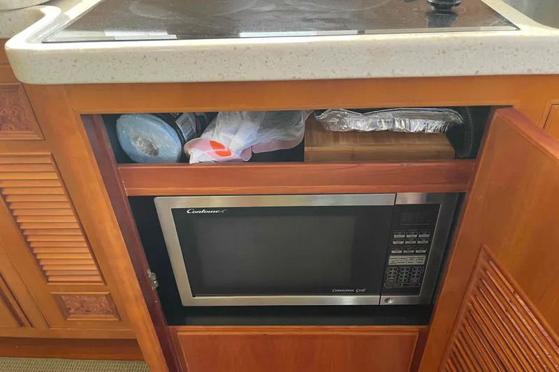 Slide: The Image of Microwave and storage in 2002 President Trawler kitchen cabinet. - 57
