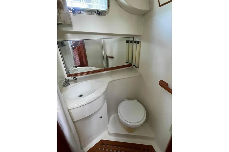 Slide: The Image of Compact bathroom in 2002 President Trawler with sink, toilet, and mirror. - 63