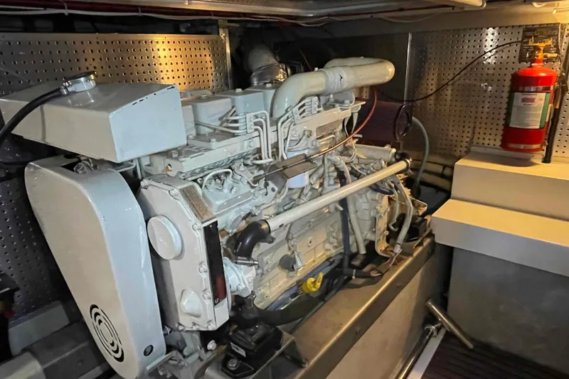 Slide: The Image of Engine room of a 2002 President Trawler with visible machinery and fire extinguisher. - 83