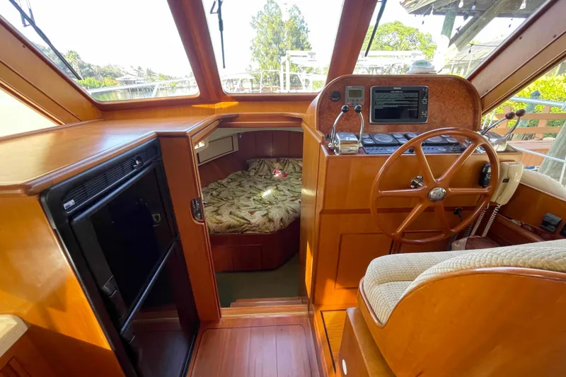 Slide: The Image of 2002 President Trawler interior with helm, cozy cabin, and wooden finishes. - 39