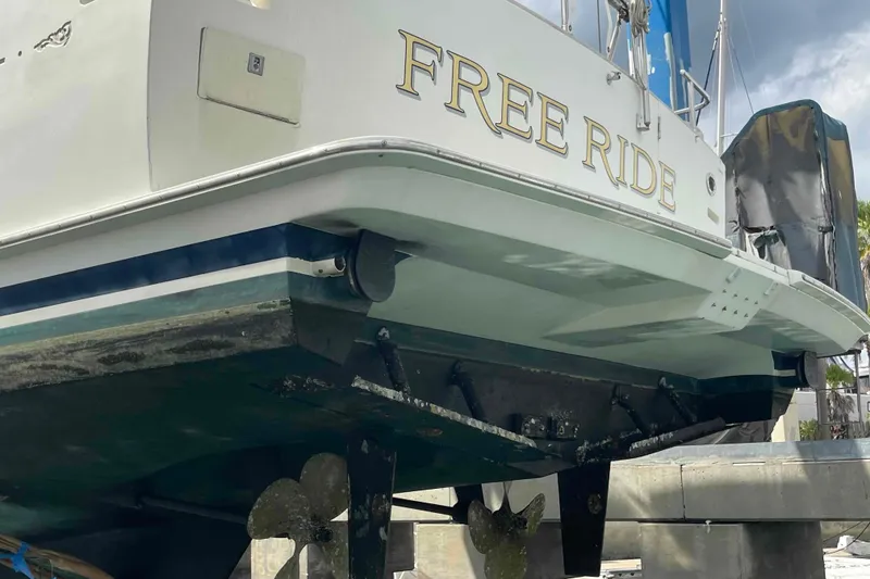 Slide: The Image of 2002 President Trawler "Free Ride" on dry dock, showcasing hull and propellers. - 113