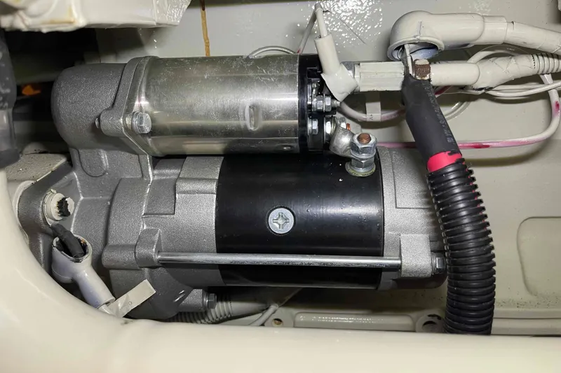 Slide: The Image of Engine component of a 2002 President Trawler, featuring wiring and metallic parts. - 99