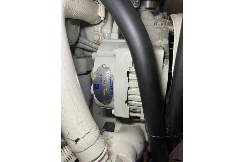 Slide: The Image of Engine component of a 2002 President Trawler with visible Cummins label and hoses. - 104