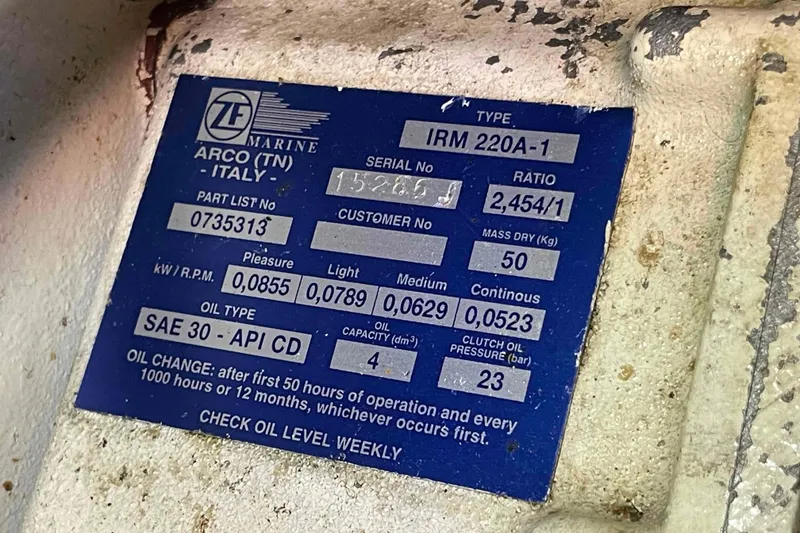 Slide: The Image of Label on a 2002 President Trawler engine, detailing specifications and oil change instructions. - 93