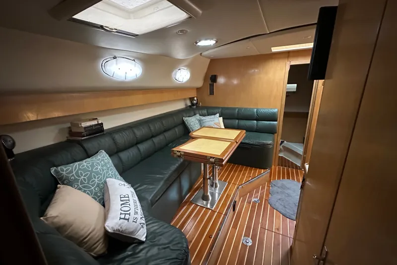 Slide: The Image of Luxurious interior of a 1997 Tiara Yachts 4000 Express with plush seating and wooden accents. - 21